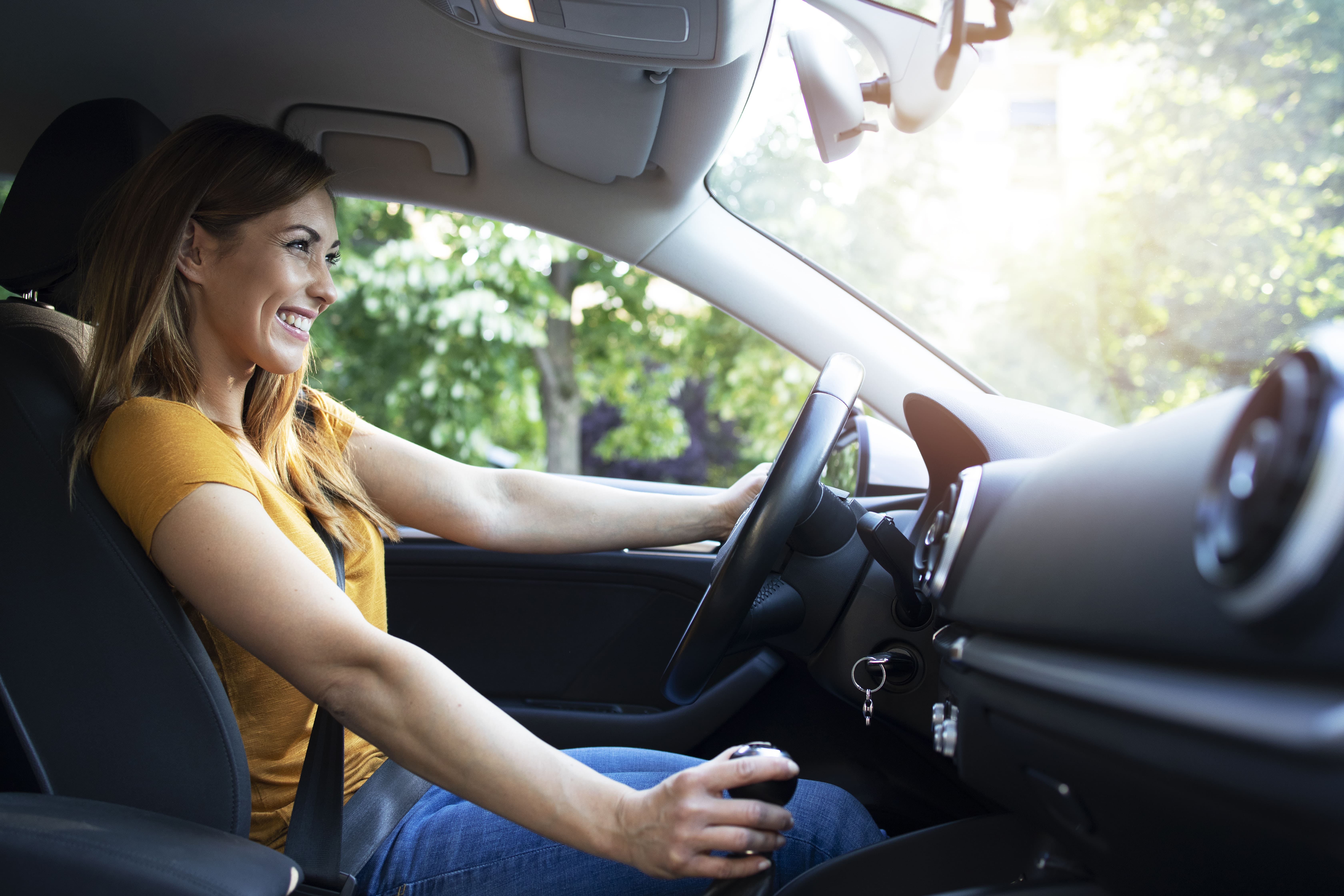 Mão masculina segurando voltante de um carro